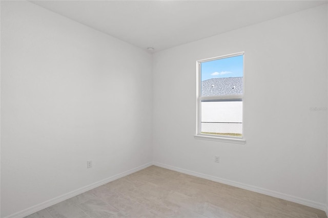 empty room featuring baseboards