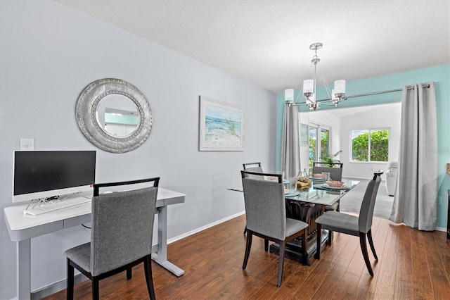 dining space with an inviting chandelier, baseboards, and dark wood-type flooring