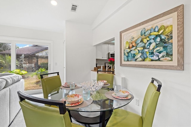 dining room featuring recessed lighting, visible vents, and vaulted ceiling