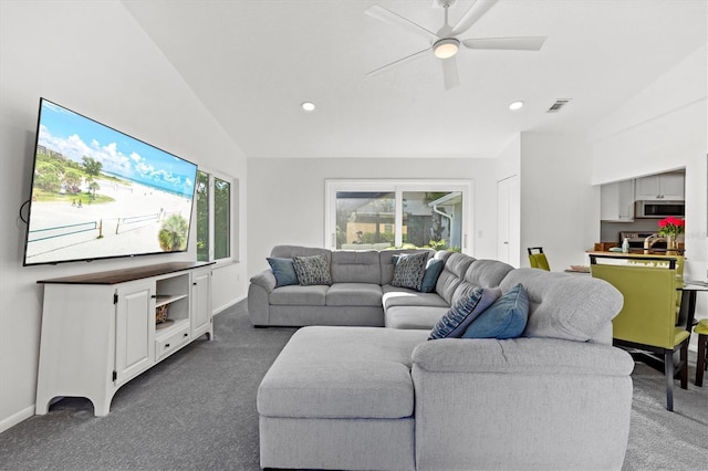 carpeted living room featuring ceiling fan, plenty of natural light, visible vents, and vaulted ceiling