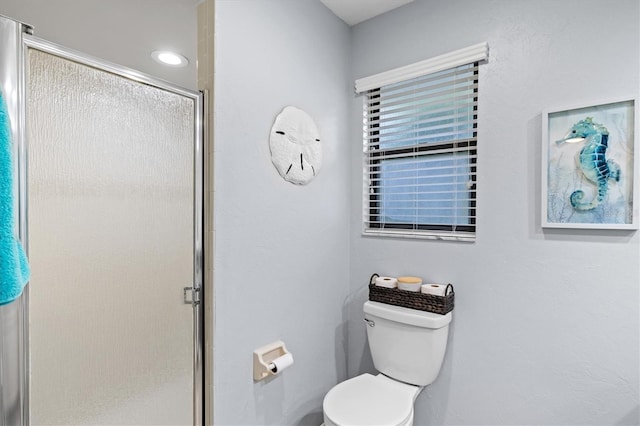 full bathroom with a stall shower and toilet