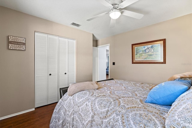 bedroom featuring ceiling fan, visible vents, baseboards, a closet, and dark wood finished floors