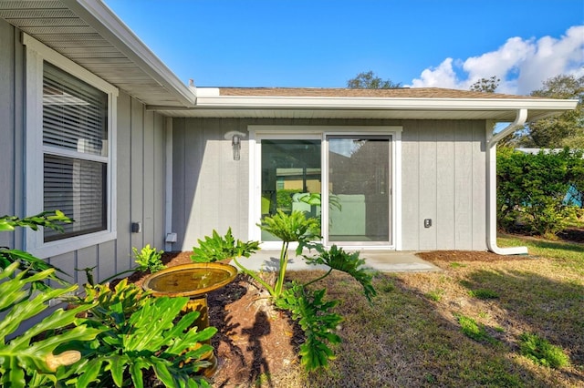 entrance to property featuring a lawn