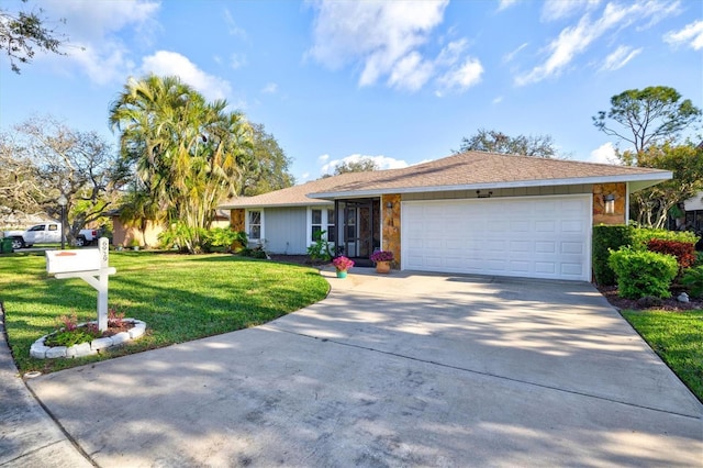 single story home featuring driveway, a garage, and a front lawn