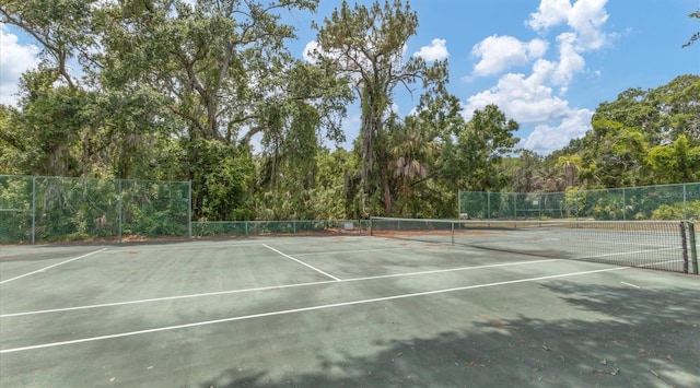 view of sport court featuring fence