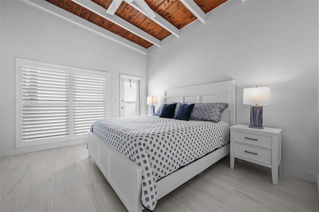 bedroom with vaulted ceiling with beams, light tile patterned floors, wood ceiling, and baseboards