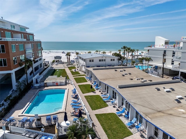 drone / aerial view with a water view and a beach view