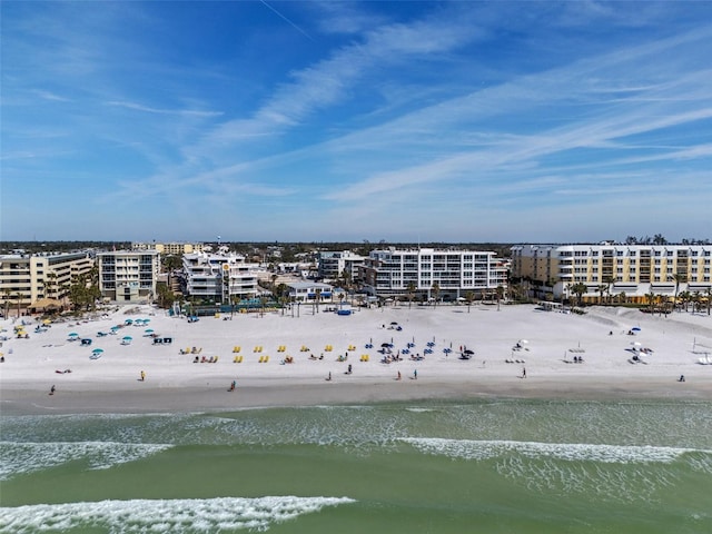 drone / aerial view featuring a beach view and a water view