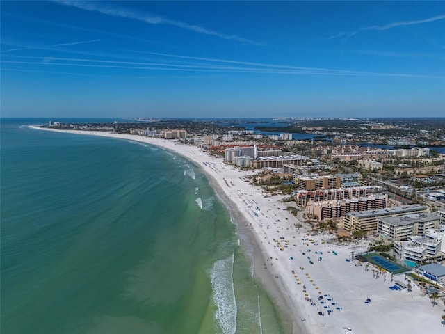 drone / aerial view featuring a view of city, a beach view, and a water view