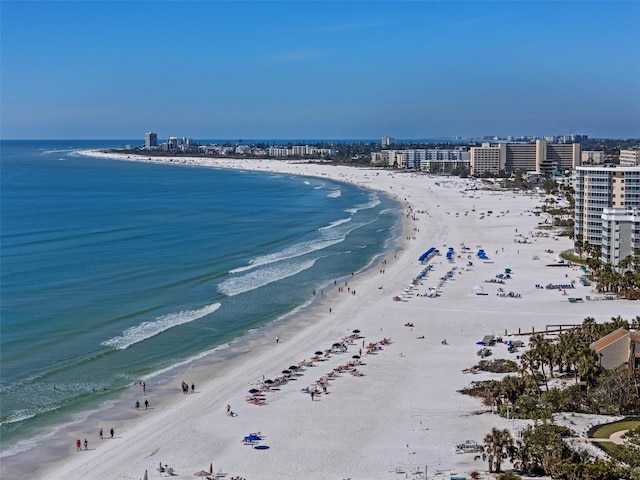 aerial view with a water view, a view of city, and a beach view