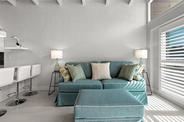 living room featuring baseboards and light tile patterned floors