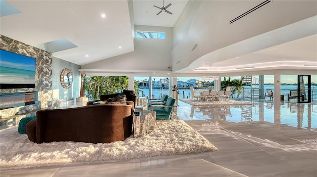 living area featuring a towering ceiling, a water view, and visible vents