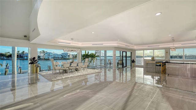 interior space featuring recessed lighting and a raised ceiling