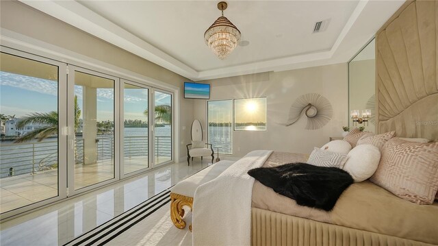 bedroom with visible vents, a raised ceiling, radiator heating unit, access to exterior, and a notable chandelier