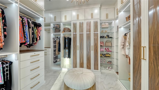 spacious closet with marble finish floor