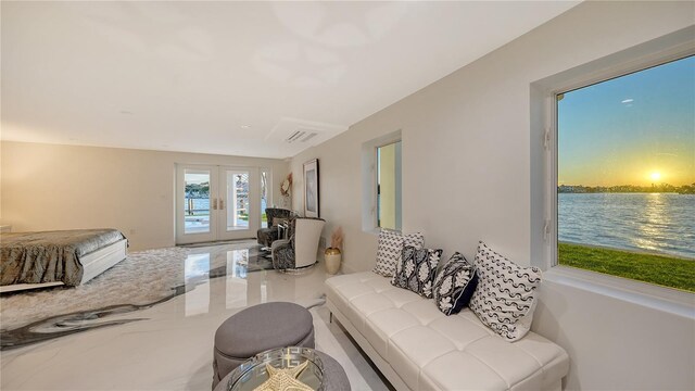 living room with marble finish floor, visible vents, and french doors