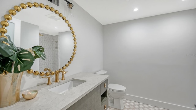 bathroom with visible vents, vanity, toilet, and baseboards