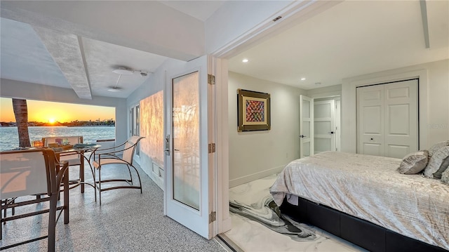 bedroom with a closet, recessed lighting, and baseboards