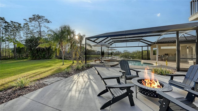 view of patio / terrace featuring glass enclosure, an outdoor fire pit, and an outdoor pool