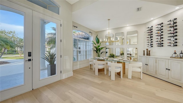 dining room with visible vents, an inviting chandelier, french doors, light wood-type flooring, and recessed lighting