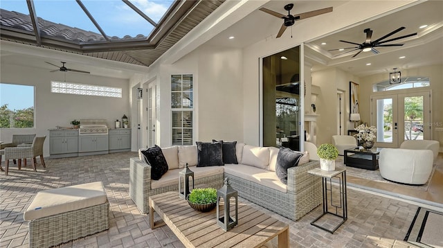 view of patio / terrace with ceiling fan, an outdoor kitchen, a lanai, french doors, and grilling area