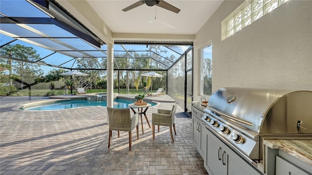 exterior space featuring an outdoor kitchen, a lanai, a pool with connected hot tub, a ceiling fan, and grilling area