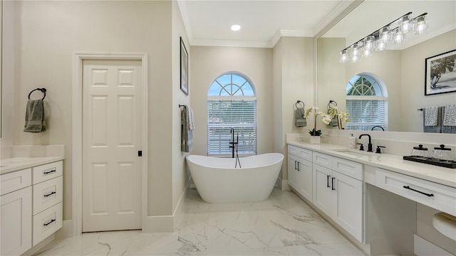 bathroom with ornamental molding, marble finish floor, a freestanding bath, and vanity