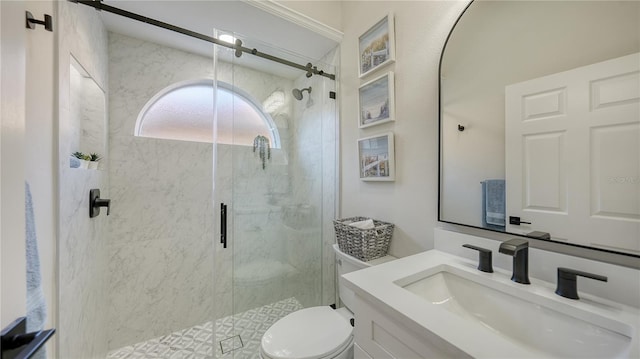 bathroom with a stall shower, vanity, and toilet