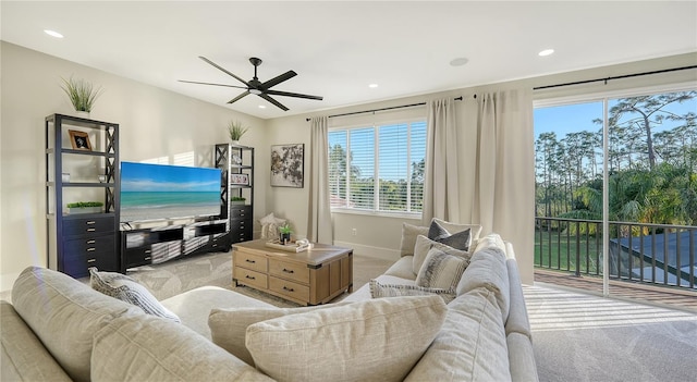 living area with carpet floors, recessed lighting, ceiling fan, and baseboards