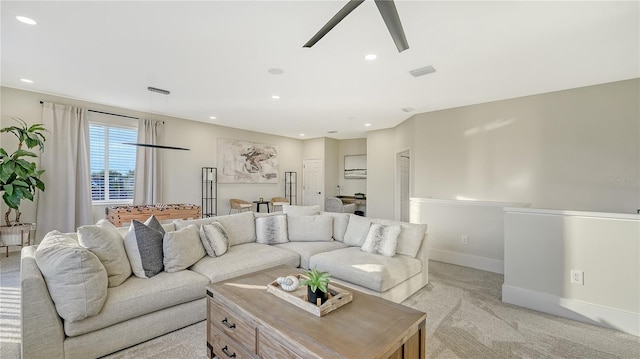 living area featuring light carpet, baseboards, visible vents, a ceiling fan, and recessed lighting