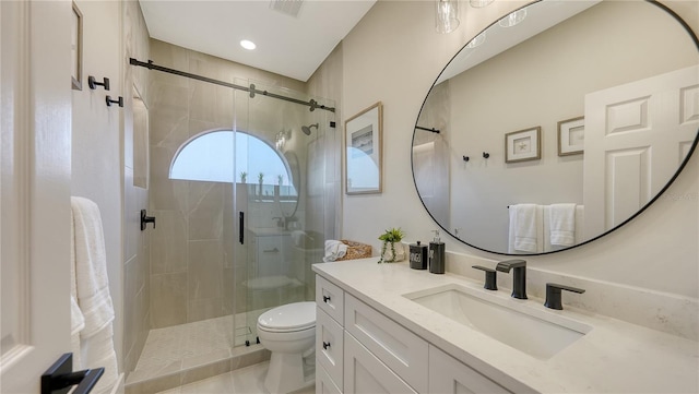 bathroom featuring a stall shower, visible vents, vanity, and toilet