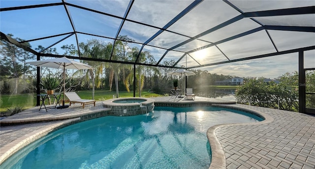 view of swimming pool with a patio area, a pool with connected hot tub, and glass enclosure