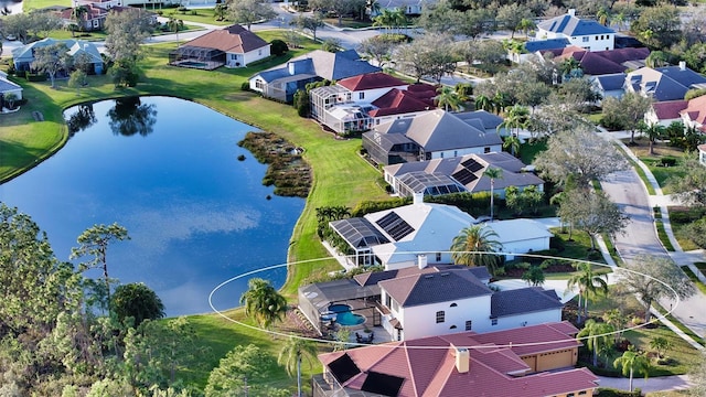 drone / aerial view featuring a residential view and a water view