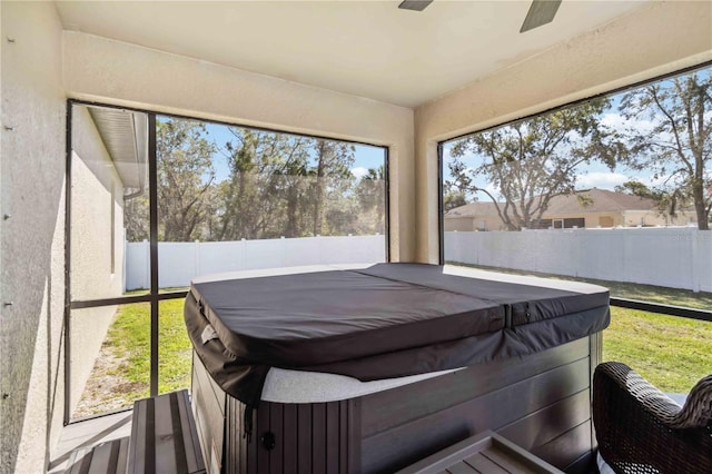 sunroom / solarium featuring a ceiling fan