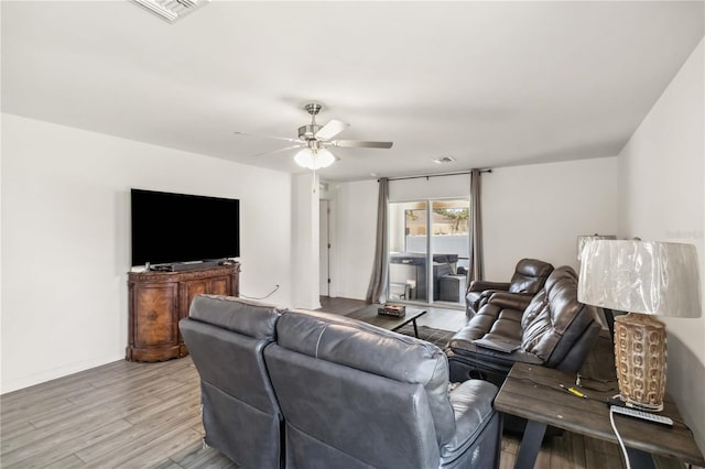 living area with visible vents, ceiling fan, and wood finished floors