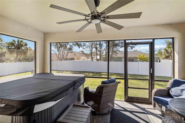 sunroom featuring a ceiling fan