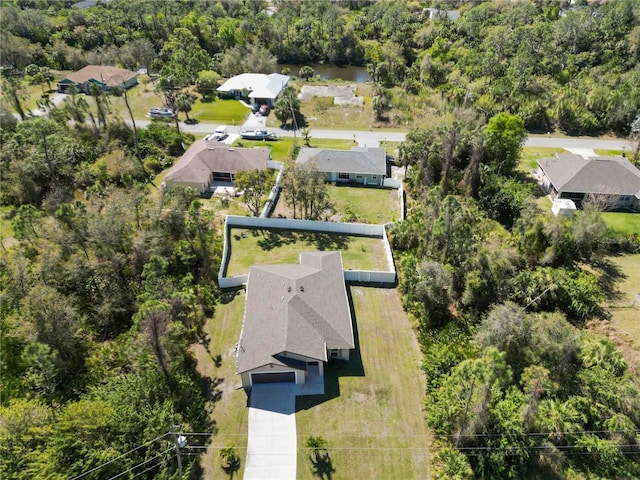 birds eye view of property featuring a view of trees