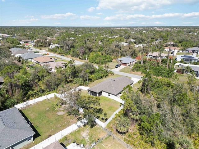 aerial view featuring a forest view and a residential view