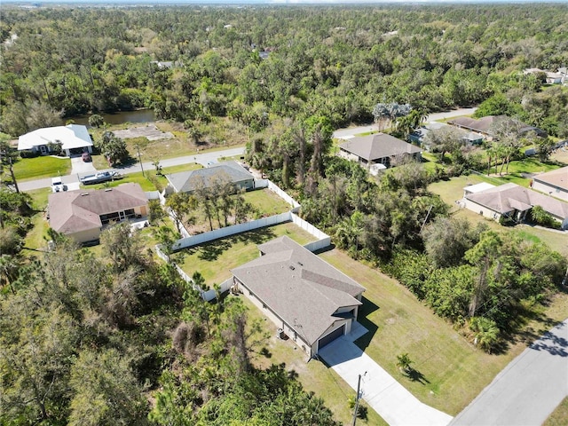 drone / aerial view with a residential view and a view of trees