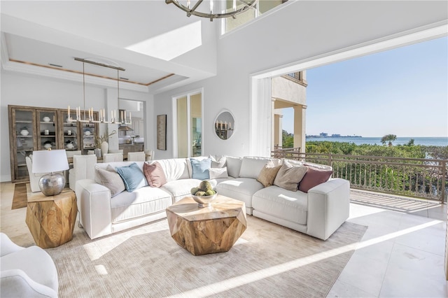 3935 N Shell Rd, Sarasota, FL 34242 - tiled living area with plenty of natural light, a chandelier, a tray ceiling, a towering ceiling, and a water view