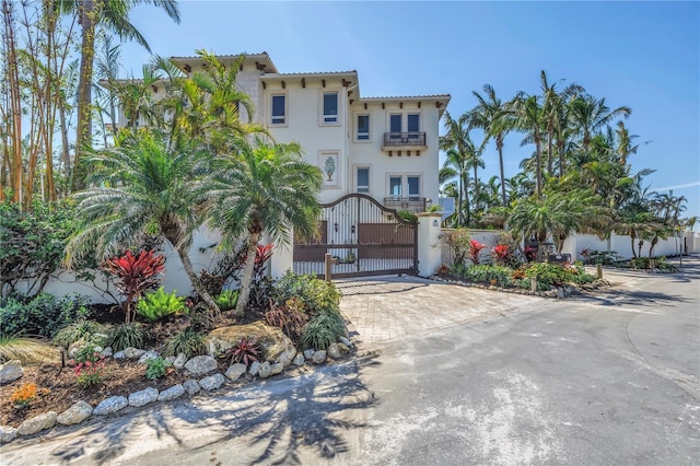 3935 N Shell Rd, Sarasota, FL 34242 - mediterranean / spanish house featuring a balcony, a gate, decorative driveway, and stucco siding