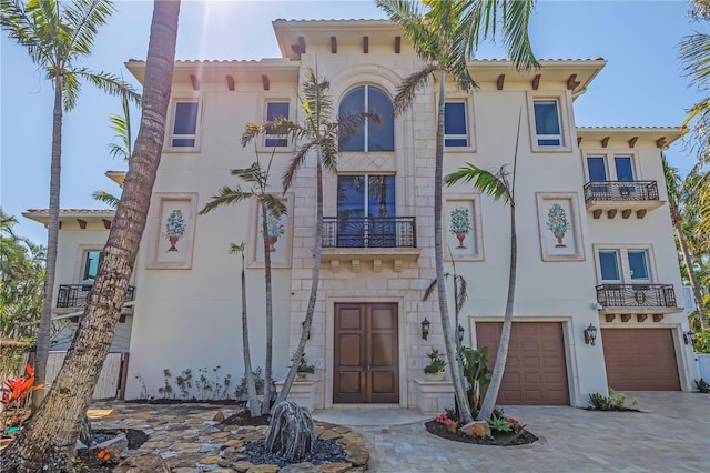 3935 N Shell Rd, Sarasota, FL 34242 - mediterranean / spanish home with a balcony, a garage, stone siding, and stucco siding