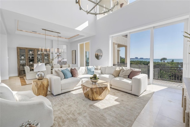 3935 N Shell Rd, Sarasota, FL 34242 - living room with a chandelier, light tile patterned floors, and a tray ceiling