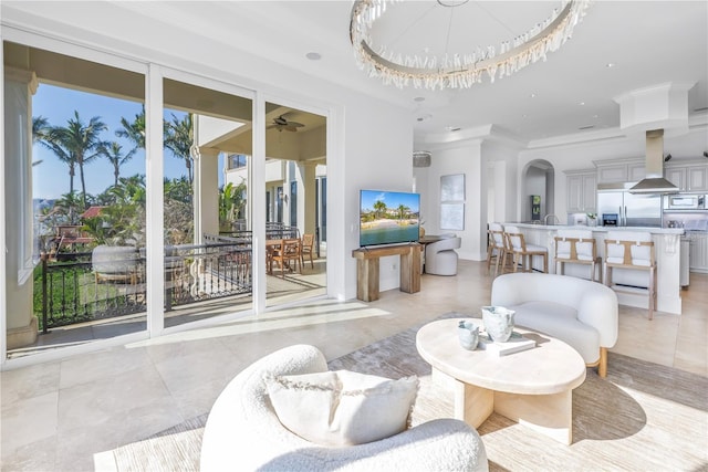 3935 N Shell Rd, Sarasota, FL 34242 - living area with a ceiling fan, light tile patterned floors, arched walkways, and crown molding