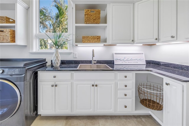 3935 N Shell Rd, Sarasota, FL 34242 - washroom with cabinet space, washing machine and dryer, and light tile patterned floors