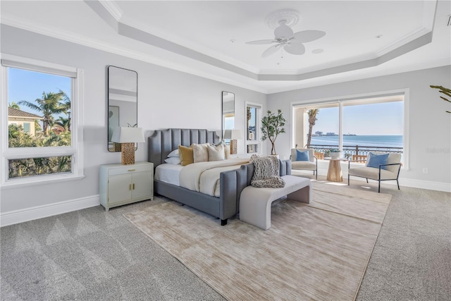3935 N Shell Rd, Sarasota, FL 34242 - bedroom with a tray ceiling, light carpet, access to outside, a water view, and crown molding