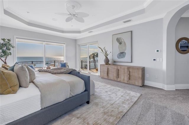 3935 N Shell Rd, Sarasota, FL 34242 - bedroom featuring a raised ceiling, access to exterior, arched walkways, crown molding, and light colored carpet