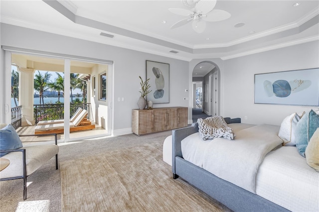 3935 N Shell Rd, Sarasota, FL 34242 - bedroom with a tray ceiling, multiple windows, arched walkways, crown molding, and carpet flooring