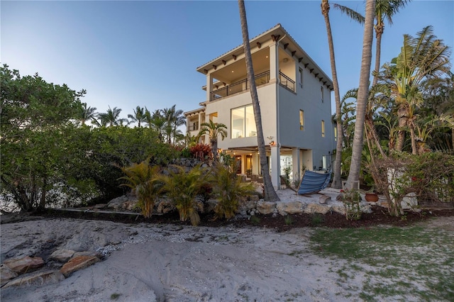 3935 N Shell Rd, Sarasota, FL 34242 - view of property exterior with a balcony, stucco siding, and a patio area