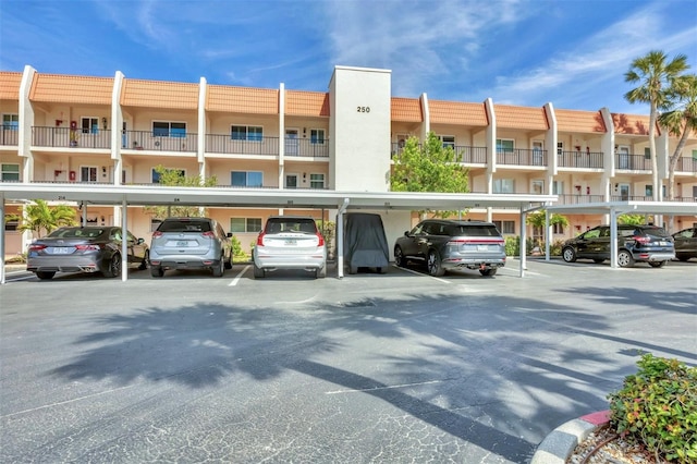 view of building exterior featuring covered parking